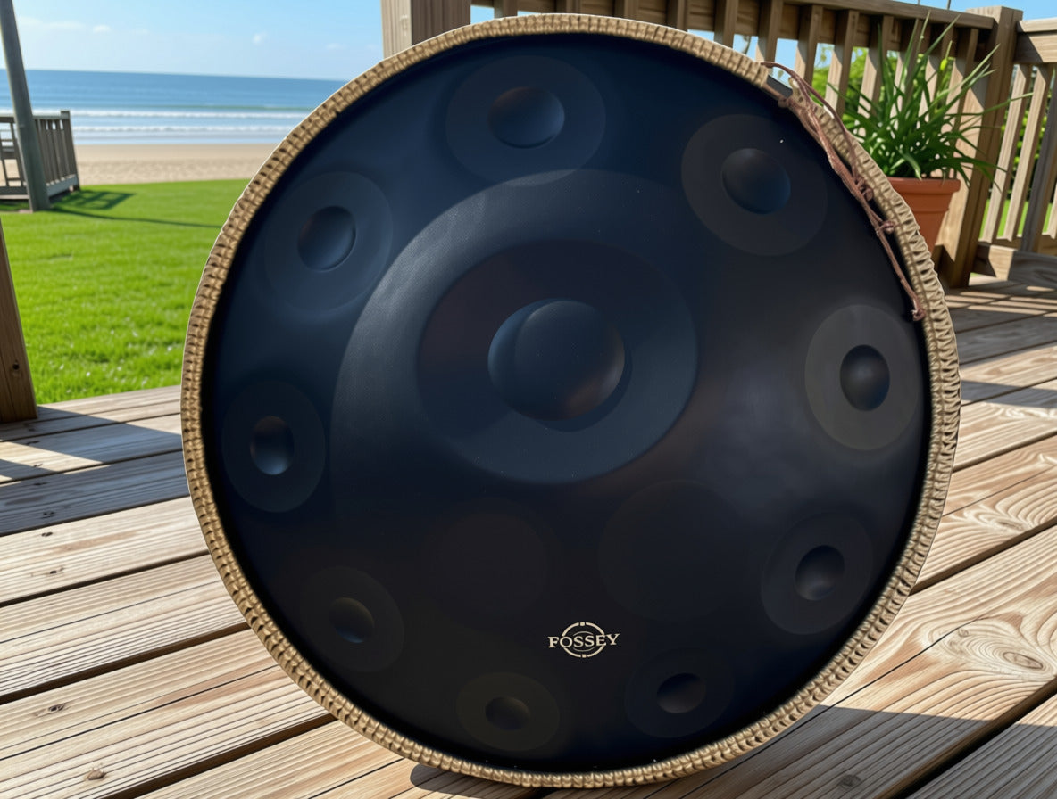 Black Fossey handpan on a seaside deck overlooking the beach