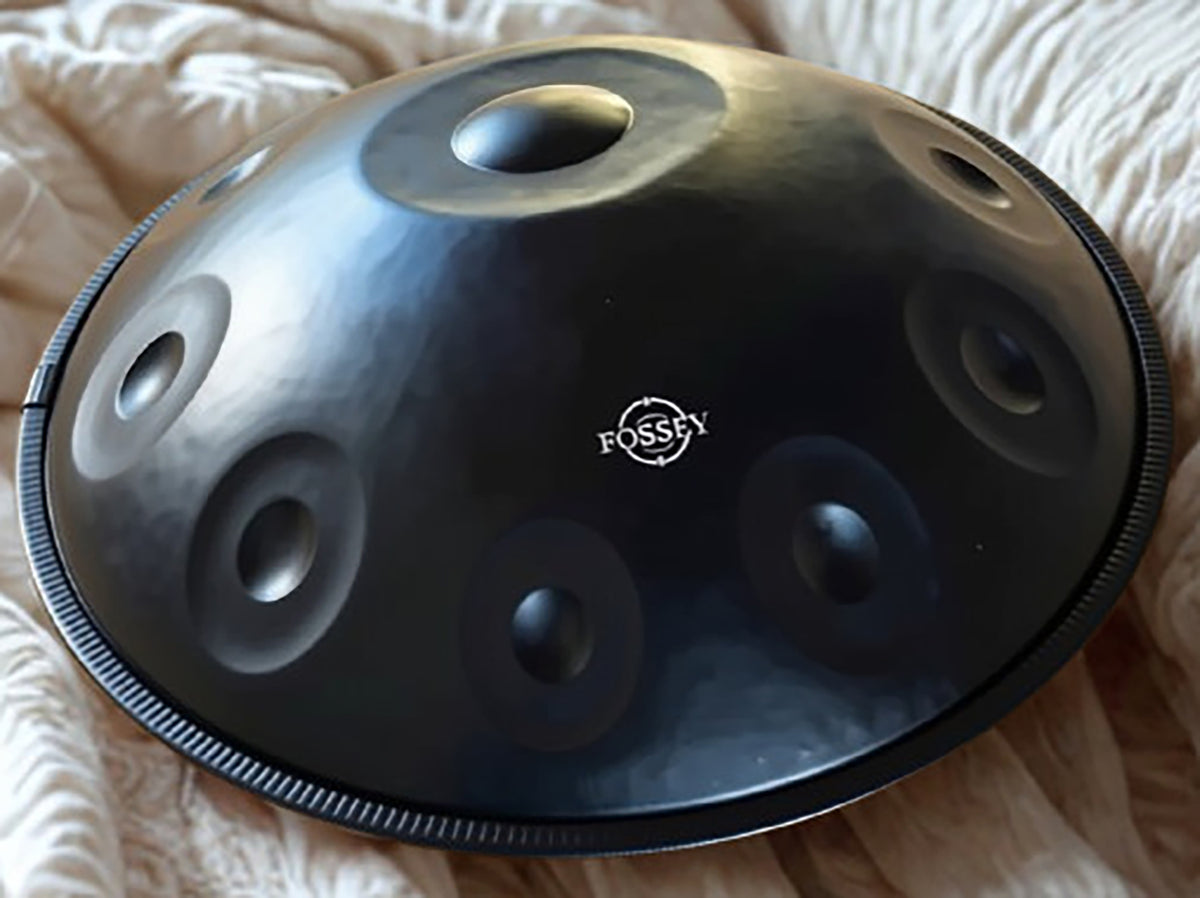 Black Fossey handpan on white textured bedding. BLACK Star 10 notes Handpan D Kurd 22' Stainless Steel 1.1 thick, Hand-Tuned ... Fossey Handpan