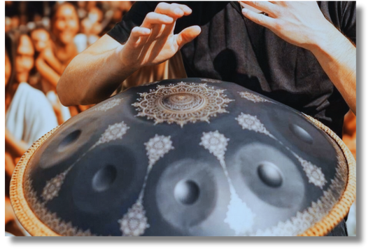 Hands playing a black Yantra handpan with mandala engravings. Black Yantra Fossey Handpan, 10-Note D Kurd, 440Hz