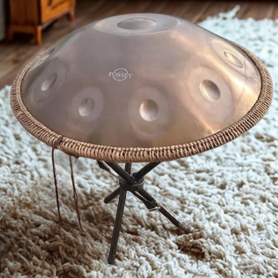 Fossey handpan gold handpan on a folding stand over a white rug