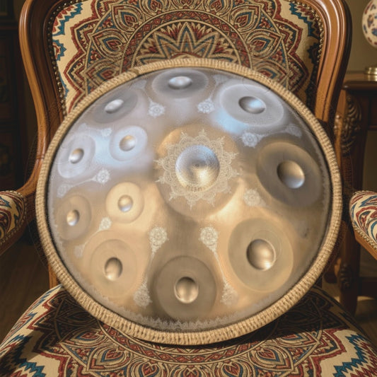 Gold Yantra Mandala handpan with engravings on a patterned chair. Gold Yantra Handpan, 12 Notes-D Kurd, Stainless Steel,