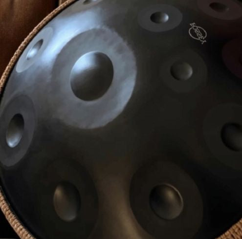 Close-up of a black Fossey handpan showing its circular tone fields